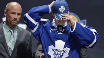 Jun 26, 2015; Sunrise, FL, USA; Mitchell Marner puts on a team cap after being selected as the number four overall pick to the Toronto Maple Leafs in the first round of the 2015 NHL Draft at BB&T Center. Mandatory Credit: Steve Mitchell-USA TODAY Sports