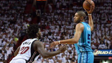 Apr 17, 2016; Miami, FL, USA; Charlotte Hornets guard Nicolas Batum (5) looks to pass the ball as Miami Heat forward Justise Winslow (20) defends during the first half in game one of the first round of the NBA Playoffs at American Airlines Arena. Mandatory Credit: Steve Mitchell-USA TODAY Sports