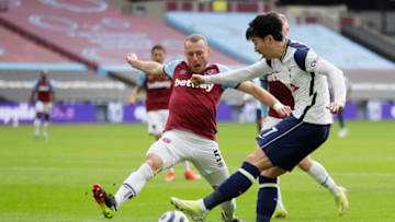LONDON, ENGLAND - FEBRUARY 21: Son Heung-Min of Tottenham Hotspur shoots whilst under pressure from Vladimir Coufal of West Ham United during the Premier League match between West Ham United and Tottenham Hotspur at London Stadium on February 21, 2021 in London, England. (Photo by Kirsty Wigglesworth - Pool/Getty Images)