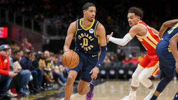 Mar 13, 2022; Atlanta, Georgia, USA; Indiana Pacers guard Tyrese Haliburton (0) drives past Atlanta Hawks guard Trae Young (11) in the first quarter at State Farm Arena. Mandatory Credit: Brett Davis-USA TODAY Sports