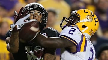 BATON ROUGE, LA - NOVEMBER 28: Josh Reynolds #11 of the Texas A&M Aggies catches a pass under pressure from Kevin Toliver II #2 of the LSU Tigers at Tiger Stadium on November 28, 2015 in Baton Rouge, Louisiana. (Photo by Chris Graythen/Getty Images)