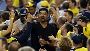ATLANTA, GA - APRIL 08: Former Michigan Wolverines player Juwan Howard greets Michigan fans in the stands against the Louisville Cardinals during the 2013 NCAA Men's Final Four Championship at the Georgia Dome on April 8, 2013 in Atlanta, Georgia. (Photo by Andy Lyons/Getty Images)