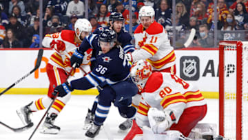 Apr 29, 2022; Winnipeg, Manitoba, CAN; Winnipeg Jets center Morgan Barron (36) takes a shot on Calgary Flames goaltender Dan Vladar (80) in the second period at Canada Life Centre. Mandatory Credit: James Carey Lauder-USA TODAY Sports