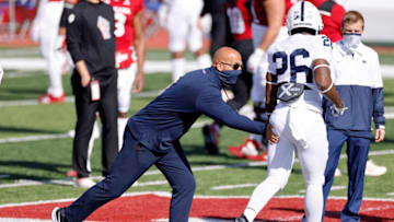 BLOOMINGTON, IN - OCTOBER 24: Head coach James Franklin of the Penn State Nittany Lions pats the rear end of Caziah Holmes #26 before a game against the Indiana Hoosiers at Memorial Stadium on October 24, 2020 in Bloomington, Indiana. Indiana won 36-35 overtime. (Photo by Joe Robbins/Getty Images)