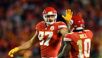 Tight end Travis Kelce #87 of the Kansas City Chiefs high-fives wide receiver Tyreek Hill #10 (Photo by Peter Aiken/Getty Images)