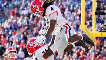 James Cook #4 of the Georgia Bulldogs celebrates with Justin Shaffer #54 after scoring a touchdown during the second quarter of a game against the Florida Gators at TIAA Bank Field on October 30, 2021 in Jacksonville, Florida. (Photo by James Gilbert/Getty Images)