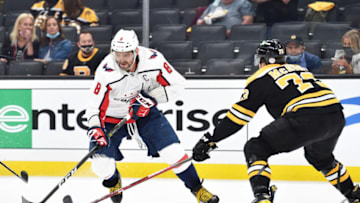 May 21, 2021; Boston, Massachusetts, USA; Washington Capitals left wing Alex Ovechkin (8) controls the puck while Boston Bruins defenseman Charlie McAvoy (73) defends during the third period in game four of the first round of the 2021 Stanley Cup Playoffs at TD Garden. Mandatory Credit: Bob DeChiara-USA TODAY Sports