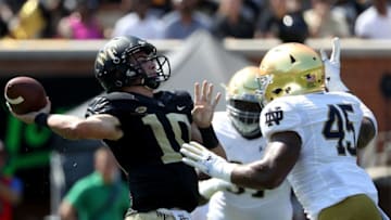 WINSTON SALEM, NC - SEPTEMBER 22: Sam Hartman #10 of the Wake Forest Demon Deacons drops back to pass against Jonathan Jones #45 of the Notre Dame Fighting Irish during their game at BB&T Field on September 22, 2018 in Winston Salem, North Carolina. (Photo by Streeter Lecka/Getty Images)