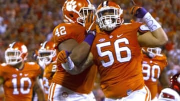 Oct 1, 2016; Clemson, SC, USA; Clemson Tigers defensive tackle Scott Pagano (56) celebrates with defensive lineman Christian Wilkins (42) after the play during the first quarter against the Louisville Cardinals at Clemson Memorial Stadium. Mandatory Credit: Joshua S. Kelly-USA TODAY Sports