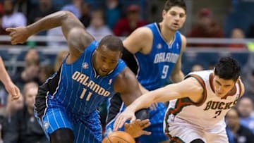 Feb 18, 2014; Milwaukee, WI, USA; Orlando Magic forward Glen Davis (11) and Milwaukee Bucks forward Ersan Ilyasova (7) reach for the loose ball during the first quarter at BMO Harris Bradley Center. Mandatory Credit: Jeff Hanisch-USA TODAY Sports