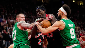 Mar 28, 2022; Toronto, Ontario, CAN; Toronto Raptors forward Pascal Siakam (43) grabs a rebound from Boston Celtics center Daniel Theis (27) and guard Derrick White (9) during the overtime at Scotiabank Arena. Mandatory Credit: John E. Sokolowski-USA TODAY Sports