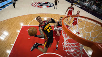 WASHINGTON, DC - MARCH 04: John Collins #20 of the Atlanta Hawks goes to the basket against Kyle Kuzma #33 of the Washington Wizards during the second half at Capital One Arena on March 4, 2022 in Washington, DC. NOTE TO USER: User expressly acknowledges and agrees that, by downloading and or using this photograph, User is consenting to the terms and conditions of the Getty Images License Agreement. (Photo by Scott Taetsch/Getty Images)