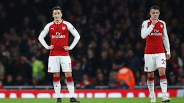 LONDON, ENGLAND - DECEMBER 22: Mesut Ozil and Granit Xhaka of Arsenal look dejected as Philippe Coutinho of Liverpool scores the first goal during the Premier League match between Arsenal and Liverpool at Emirates Stadium on December 22, 2017 in London, England. (Photo by Julian Finney/Getty Images)
