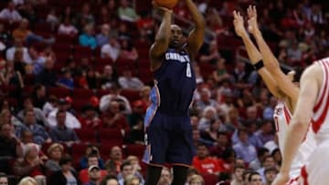 Feb 2, 2013; Houston, TX, USA; Charlotte Bobcats shooting guard Ben Gordon (8) shoots against Houston Rockets small forward Carlos Delfino (10) during the first quarter at the Toyota Center. Mandatory Credit: Thomas Campbell-USA TODAY Sports