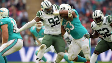 Oct 4, 2015; London, United Kingdom; New York Jets defensive end Leonard Williams (92) tries to get past Miami Dolphins left guard Dallas Thomas (63) in Game 12 of the NFL International Series at Wembley Stadium.The Jets defeated the Dolphins 27-14. Mandatory Credit: Kirby Lee-USA TODAY Sports