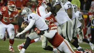 Jan 3, 2016; Kansas City, MO, USA; Kansas City Chiefs nose tackle Jaye Howard (96) sacks Oakland Raiders quarterback Derek Carr (4) in the second half at Arrowhead Stadium. Kansas City won the game 23-17. Mandatory Credit: John Rieger-USA TODAY Sports