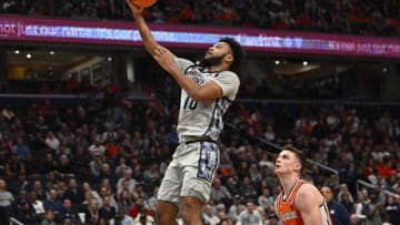 Dec 9, 2023; Washington, District of Columbia, USA; Georgetown Hoyas guard Jayden Epps (10) shoots as Syracuse Orange center Naheem McLeod (10) looks on during the second half at Capital One Arena. Mandatory Credit: Brad Mills-USA TODAY Sports