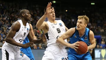 05 February 2019, Berlin: Basketball: Eurocup, ALBA Berlin - Partizan Belgrade, intermediate round, Group E, 6th matchday. f.l. Bandja Sy and Vanja Marinkovic from Partizan Belgrade defend against Albas Niels Giffey. Photo: Andreas Gora/dpa (Photo by Andreas Gora/picture alliance via Getty Images)