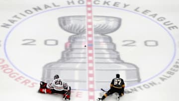 Corey Crawford #50 of the Chicago Blackhawks stretches along with Max Pacioretty #67 of the Vegas Golden Knights before the start of Game One of the Western Conference First Round during the 2020 NHL Stanley Cup Playoffs. (Photo by Jeff Vinnick/Getty Images)