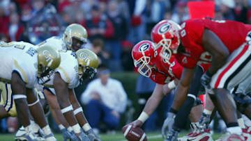 Center Ian Knight #56 of Georgia and the offensive line ready for the snap against Alfred Malone #92 of Georgia Tech and the defensive line on November 30, 2002 at Sanford Stadium in Athens, Georgia. Georgia won 51-7. (Photo by Jamie Squire/Getty Images)