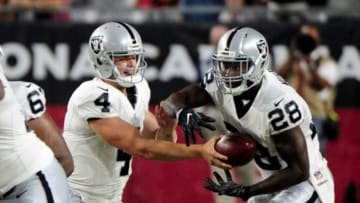 Aug 12, 2016; Glendale, AZ, USA; Oakland Raiders quarterback Derek Carr (4) hands off to running back Latavius Murray (28) during the first half against the Arizona Cardinals at University of Phoenix Stadium. Mandatory Credit: Matt Kartozian-USA TODAY Sports