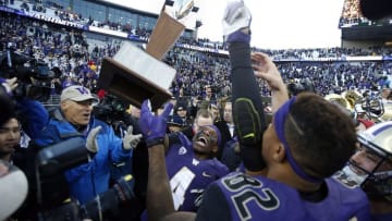 Nov 27, 2015; Seattle, WA, USA; Washington Huskies wide receiver Jaydon Mickens (4) lifts up the Apple Cup trophy while Washington governor Jay Inslee (left) claps after the Huskies defeated the Washington State Cougars 45-10 at Husky Stadium. Mandatory Credit: Jennifer Buchanan-USA TODAY Sports
