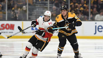 BOSTON, MA - JANUARY 3: David Pastrnak #88 of the Boston Bruins against Johnny Gaudreau #13 of the Calgary Flames at the TD Garden on January 3, 2019 in Boston, Massachusetts. (Photo by Steve Babineau/NHLI via Getty Images)