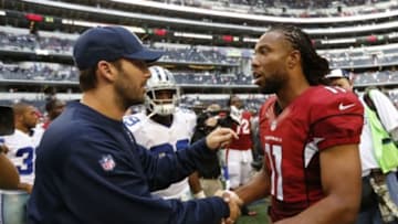 Nov 2, 2014; Arlington, TX, USA; Arizona Cardinals wide receiver Larry Fitzgerald (11) meets with Dallas Cowboys injured quarterback Tony Romo (9) at AT&T Stadium. The Cardinals beat the Cowboys 28-17. Mandatory Credit: Matthew Emmons-USA TODAY Sports