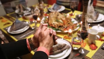 STAMFORD, CT - NOVEMBER 24: Central American immigrants and their families pray before Thanksgiving dinner on November 24, 2016 in Stamford, Connecticut. Family and friends, some of them U.S. citizens, others on work visas and some undocumented immigrants came together in an apartment to celebrate the American holiday with turkey and Latin American dishes. They expressed concern with the results of the U.S. Presidential election of president-elect Donald Trump, some saying their U.S.-born children fear the possibilty their parents will be deported after Trump's inauguration. (Photo by John Moore/Getty Images)