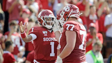NORMAN, OK - SEPTEMBER 28: Quarterback Jalen Hurts #2 celebrates his touchdown with left tackle Erik Swenson #77 of the Oklahoma Sooners against the Texas Tech Red Raiders at Gaylord Family Oklahoma Memorial Stadium on September 28, 2019 in Norman, Oklahoma. (Photo by Brett Deering/Getty Images)