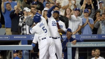 Sep 9, 2013; Los Angeles, CA, USA; Los Angeles Dodgers third baseman Juan Uribe (5) celebrates his 3rd home run of the game with shortstop Hanley Ramirez (13) during the game against the Arizona Diamondbacks at Dodger Stadium. Mandatory Credit: Richard Mackson-USA TODAY Sports
