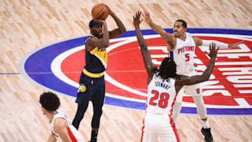 Indiana Pacers forward Justin Holiday (8) shoots as Detroit Pistons guard Cade Cunningham (2) center Isaiah Stewart (28) and guard Frank Jackson (5) defend Credit: Tim Fuller-USA TODAY Sports