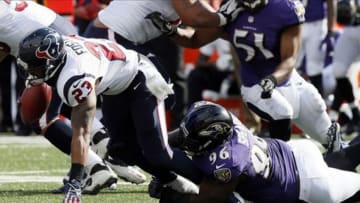 Sep 22, 2013; Baltimore, MD, USA; Houston Texans running back Arian Foster (23) is tackled for a loss by Baltimore Ravens defensive end Marcus Spears (96) at M