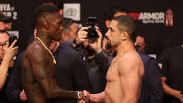 HOUSTON, TEXAS - FEBRUARY 11: Israel Adesanya of Nigeria faces off against Robert Whittaker of Australia at the ceremonial weigh in prior to UFC 271 at Toyota Center on February 11, 2022 in Houston, Texas. (Photo by Carmen Mandato/Getty Images)