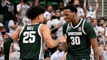 Nov 12, 2021; East Lansing, Michigan, USA; Michigan StateÕs Marcus Bingham Jr(30) celebrates with teammate Malik Hall(25) at Jack Breslin Student Events Center. Mandatory Credit: Dale Young-USA TODAY Sports