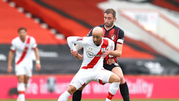 BOURNEMOUTH, ENGLAND - MARCH 20: Ryan Bertrand of Southampton and Steve Cook of AFC Bournemouth battle for the ball during The Emirates FA Cup Quarter Final match between Bournemouth and Southampton at Vitality Stadium on March 20, 2021 in Bournemouth, England. Sporting stadiums around the UK remain under strict restrictions due to the Coronavirus Pandemic as Government social distancing laws prohibit fans inside venues resulting in games being played behind closed doors. (Photo by Michael Steele/Getty Images)