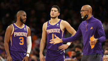 PHOENIX, ARIZONA - DECEMBER 19: Head coach Monty Williams of the Phoenix Suns talks with Chris Paul #3 and Devin Booker #1 during the second half of the NBA game against the Charlotte Hornets at Footprint Center on December 19, 2021 in Phoenix, Arizona. The Suns defeated the Hornets 137-106. NOTE TO USER: User expressly acknowledges and agrees that, by downloading and or using this photograph, User is consenting to the terms and conditions of the Getty Images License Agreement. (Photo by Christian Petersen/Getty Images)