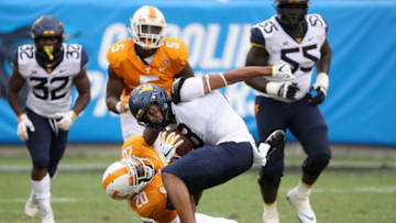 CHARLOTTE, NC - SEPTEMBER 01: Bryce Thompson #20 of the Tennessee Volunteers tries to tackle Marcus Simms #8 of the West Virginia Mountaineers during their game at Bank of America Stadium on September 1, 2018 in Charlotte, North Carolina. (Photo by Streeter Lecka/Getty Images)