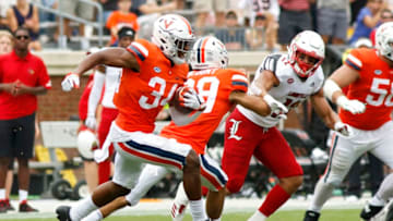 CHARLOTTESVILLE, VA - SEPTEMBER 22: Bryce Hall #34 of the Virginia Cavaliers intercepts a pass in the second half during a game against the Louisville Cardinals at Scott Stadium on September 22, 2018 in Charlottesville, Virginia. (Photo by Ryan M. Kelly/Getty Images)