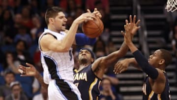 Feb 21, 2016; Orlando, FL, USA; Indiana Pacers forward Lavoy Allen (5) and center Jordan Hill (27) foul Orlando Magic center Nikola Vucevic (9) during the second half at Amway Center. Indiana Pacers defeated the Orlando Magic 105-102. Mandatory Credit: Kim Klement-USA TODAY Sports