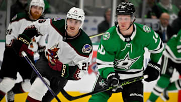 Mar 1, 2023; Dallas, Texas, USA; Arizona Coyotes center Laurent Dauphin (26) and Dallas Stars center Ty Dellandrea (10) chase the puck during the third period at the American Airlines Center. Mandatory Credit: Jerome Miron-USA TODAY Sports
