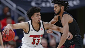 LOUISVILLE, KY - NOVEMBER 17: Jae'Lyn Withers #3 of the Louisville Cardinals tries to hold off Deven Palmer #5 of the North Carolina Central Eagles during the first half at KFC YUM! Center on November 17, 2019 in Louisville, Kentucky. (Photo by Michael Hickey/Getty Images)