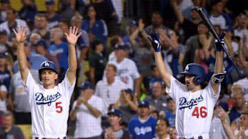 LOS ANGELES, CALIFORNIA - AUGUST 05: Corey Seager #5 and Tony Gonsolin #46 of the Los Angeles Dodgers celebrate a two run RBI double by Matt Beaty #45, to take an 8-0 lead, during the fifth inning at Dodger Stadium on August 05, 2019 in Los Angeles, California. (Photo by Harry How/Getty Images)