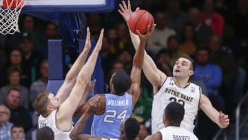 SOUTH BEND, IN - JANUARY 13: John Mooney #33 of the Notre Dame Fighting Irish goes up for the shot block as Kenny Williams #24 of the North Carolina Tar Heels shoots at Purcell Pavilion on January 13, 2018 in South Bend, Indiana. (Photo by Michael Hickey/Getty Images)