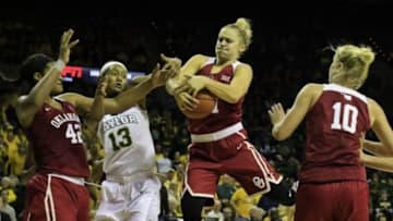 Jan 3, 2016; Waco, TX, USA; Oklahoma Sooners guard Gabbi Ortiz (21) grabs the rebound in front of Baylor Bears forward Nina Davis (13) during the second half at Ferrell Center. Baylor won 78-68. Mandatory Credit: Ray Carlin-USA TODAY Sports