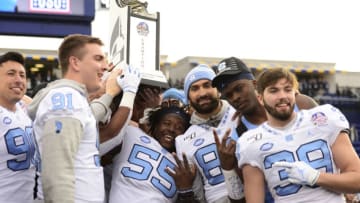 ANNAPOLIS, MD - DECEMBER 27: Members of the North Carolina Tar Heels celebrate after defeating the Temple Owls 55-13 to win the Military Bowl Presented by Northrop Grumman at Navy-Marine Corps Memorial Stadium on December 27, 2019 in Annapolis, Maryland. (Photo by Patrick McDermott/Getty Images)
