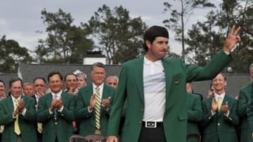 Apr 13, 2014; Augusta, GA, USA; Bubba Watson celebrates with the green jacket after winning the 2014 The Masters golf tournament at Augusta National Golf Club. Mandatory Credit: Michael Madrid-USA TODAY Sports