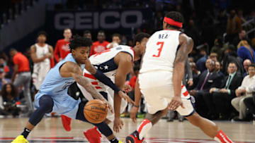 Feb 9, 2020; Washington, District of Columbia, USA; Memphis Grizzlies guard Ja Morant (12) dribbles the ball between Washington Wizards guard Ish Smith (14) and Wizards guard Bradley Beal (3) in the fourth quarter at Capital One Arena. Mandatory Credit: Geoff Burke-USA TODAY Sports