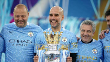 Manchester City's Spanish manager Pep Guardiola (C) holds the Premier League trophy. (Photo by Dave Thompson / POOL / AFP) / RESTRICTED TO EDITORIAL USE. No use with unauthorized audio, video, data, fixture lists, club/league logos or 'live' services. Online in-match use limited to 120 images. An additional 40 images may be used in extra time. No video emulation. Social media in-match use limited to 120 images. An additional 40 images may be used in extra time. No use in betting publications, games or single club/league/player publications. / RESTRICTED TO EDITORIAL USE. No use with unauthorized audio, video, data, fixture lists, club/league logos or 'live' services. Online in-match use limited to 120 images. An additional 40 images may be used in extra time. No video emulation. Social media in-match use limited to 120 images. An additional 40 images may be used in extra time. No use in betting publications, games or single club/league/player publications. (Photo by DAVE THOMPSON/POOL/AFP via Getty Images)