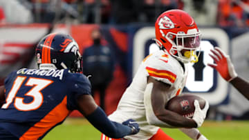 Jan 8, 2022; Denver, Colorado, USA; Kansas City Chiefs running back Jerick McKinnon (1) runs the ball against Denver Broncos cornerback Michael Ojemudia (13) in the third quarter at Empower Field at Mile High. Mandatory Credit: Ron Chenoy-USA TODAY Sports
